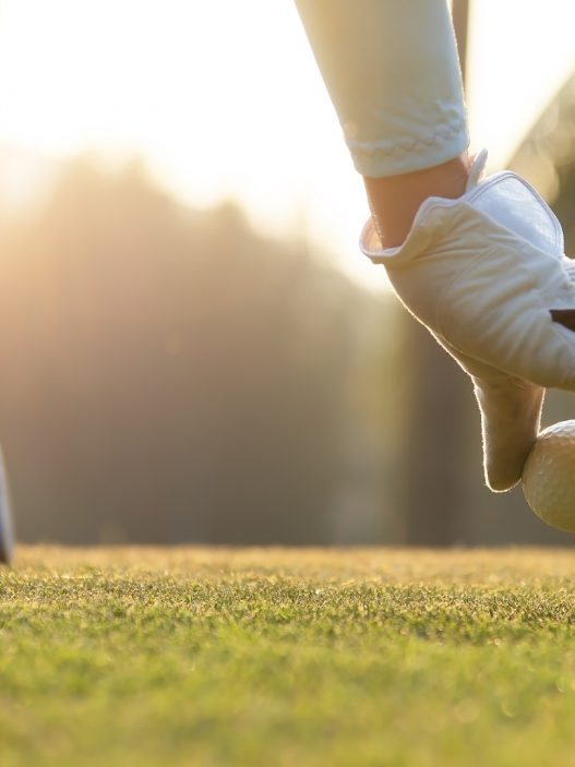 hand-of-woman-golf-player-gentle-put-a-golf-ball-onto-wooden-tee-on-picture-id1155100733